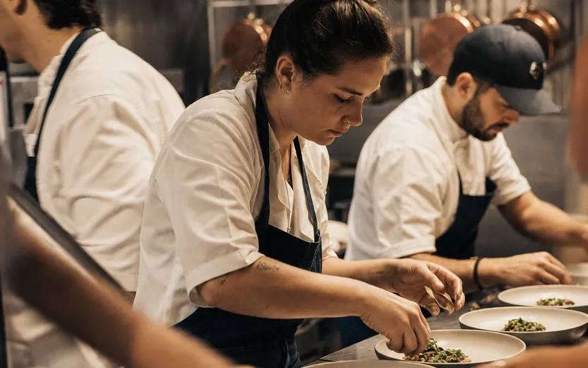 A calm, event-ready catering kitchen with the team plating in perfect flow